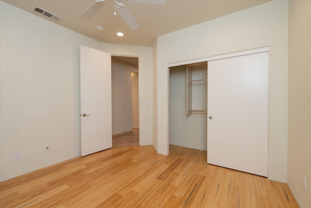 unfurnished bedroom with ceiling fan, light hardwood / wood-style flooring, and a closet