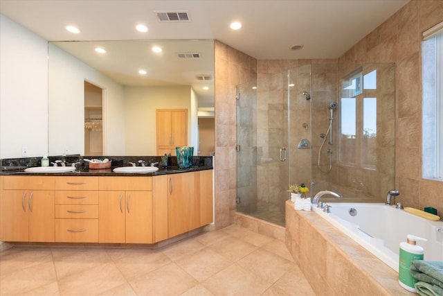 bathroom featuring vanity, tile patterned floors, and plus walk in shower