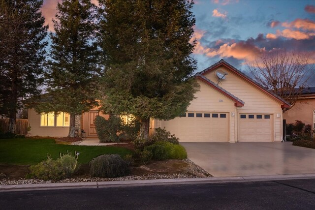 view of front of property featuring a yard and a garage