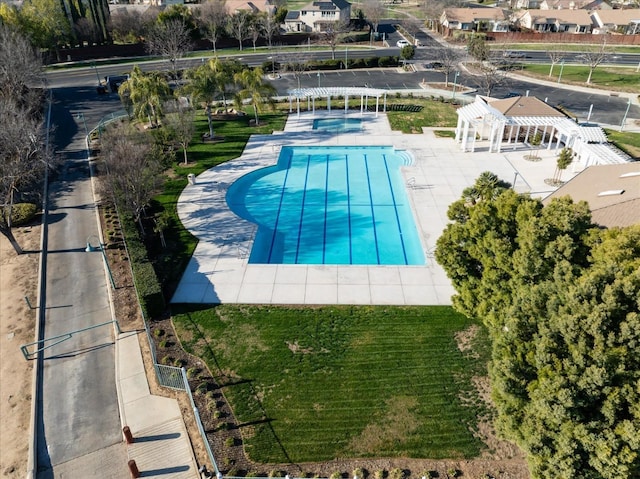 view of swimming pool featuring a patio, a yard, and a pergola