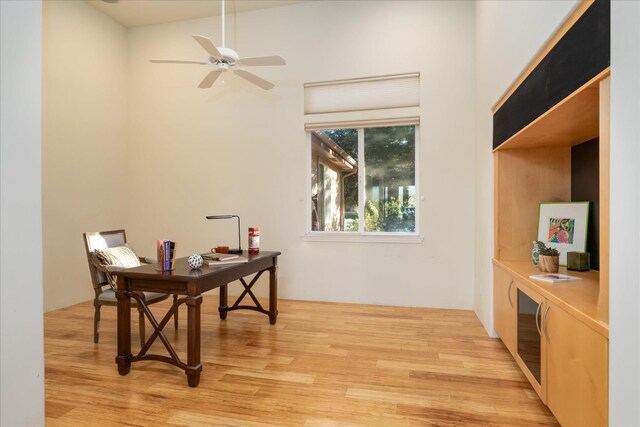 home office with ceiling fan and light hardwood / wood-style floors