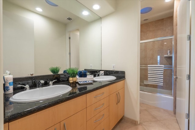 bathroom featuring tile patterned flooring, shower / bath combination with glass door, and vanity