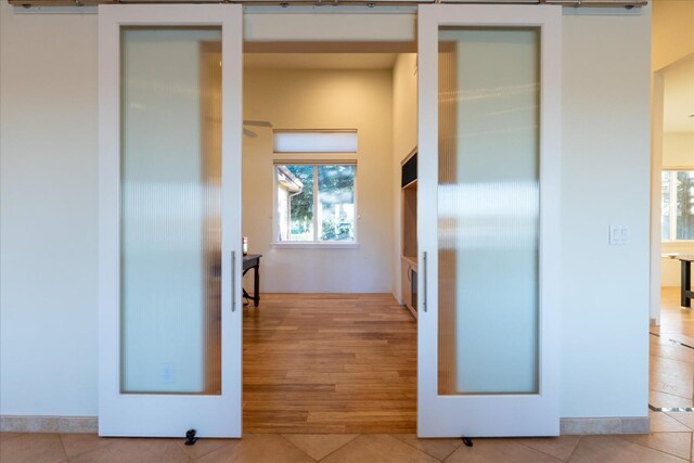 corridor with light tile patterned floors