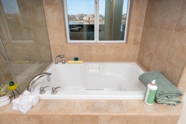 bathroom featuring tiled bath