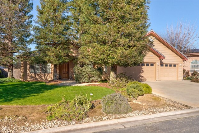 view of front of house featuring a garage and a front lawn