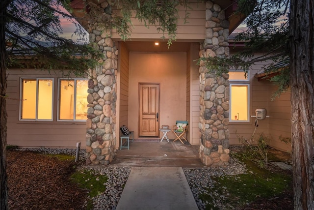 view of exterior entry at dusk