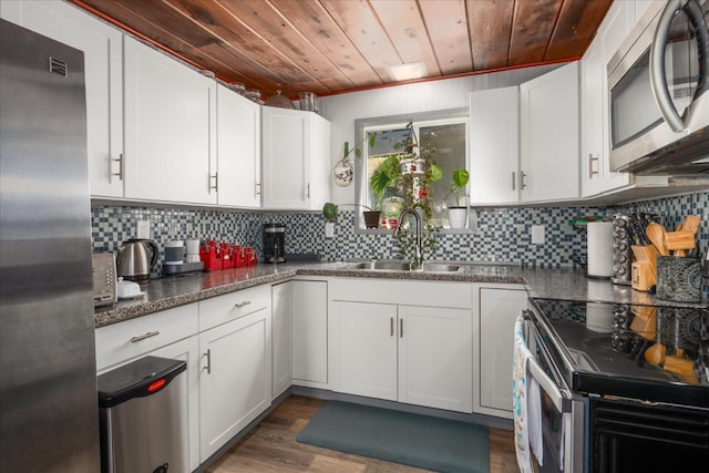 kitchen with white cabinets, stainless steel appliances, wooden ceiling, and sink