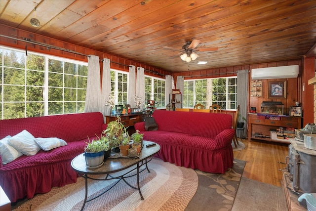 sunroom / solarium with ceiling fan, wooden ceiling, and a wall unit AC