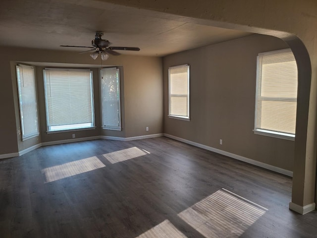 spare room featuring ceiling fan and dark hardwood / wood-style flooring