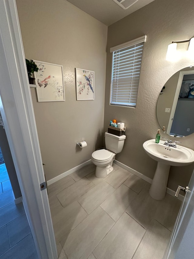 bathroom with tile patterned flooring and toilet