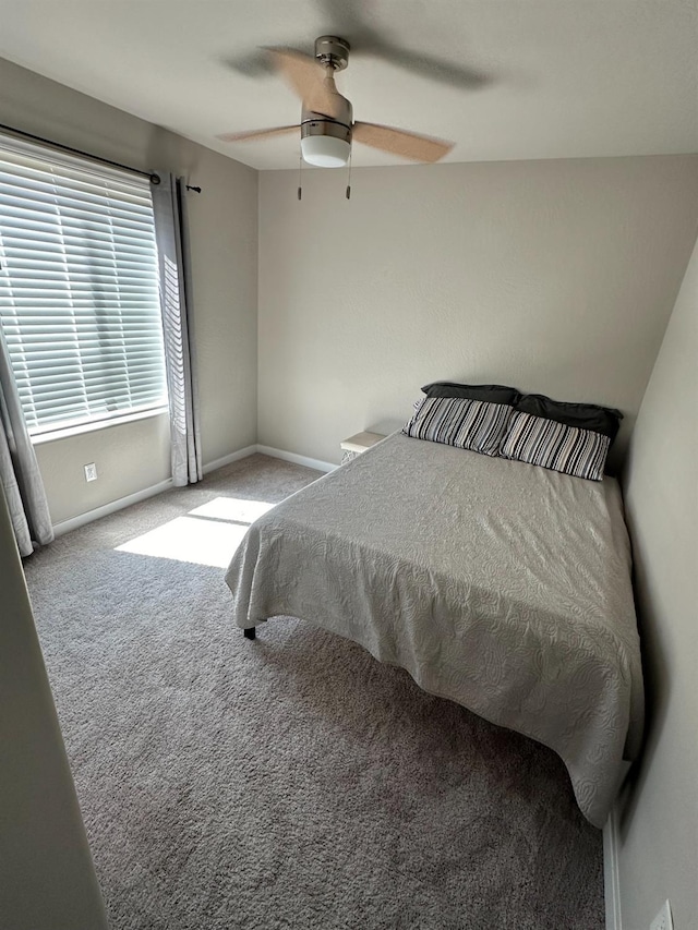 bedroom featuring ceiling fan and light carpet