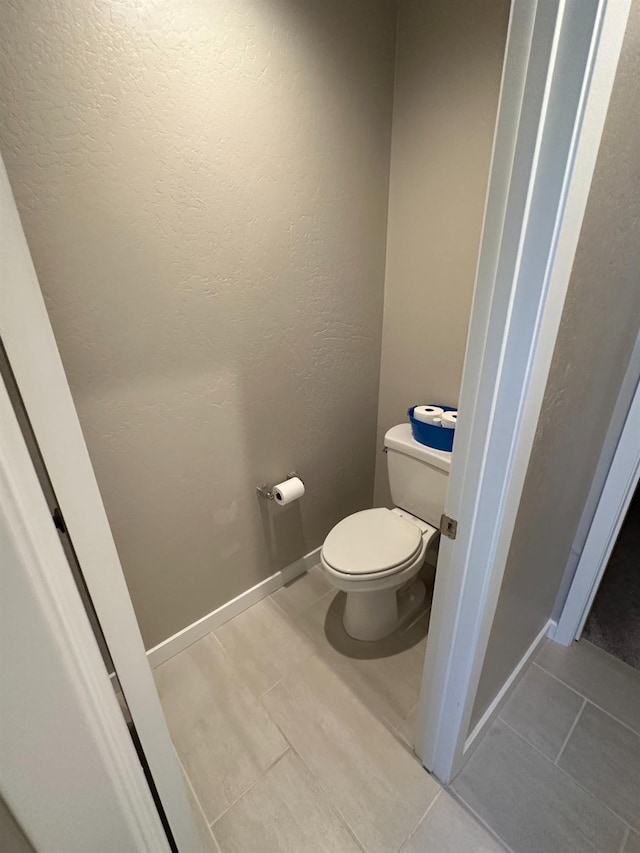 bathroom featuring tile patterned floors and toilet