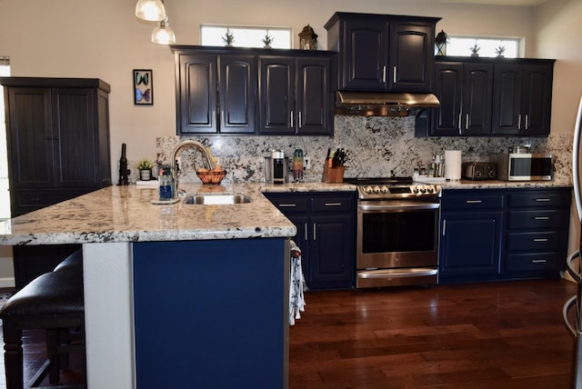 kitchen with stainless steel appliances, sink, light stone counters, tasteful backsplash, and dark wood-type flooring