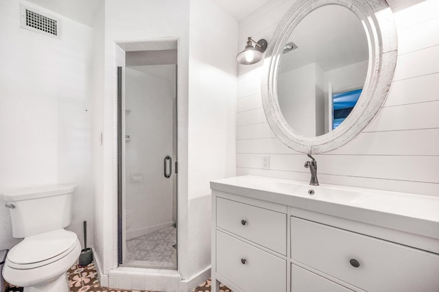 bathroom with toilet, a shower with door, and vanity