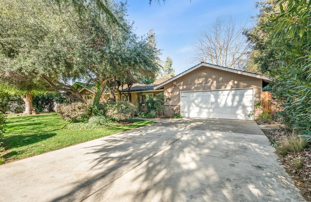 ranch-style home with a garage and a front lawn