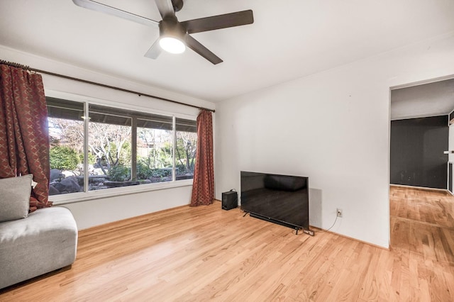 living area with light wood-type flooring and ceiling fan