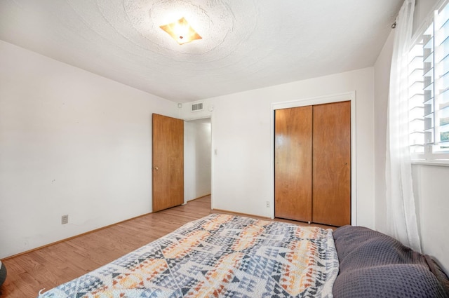 bedroom with a closet and light wood-type flooring