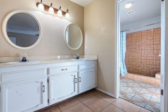 bathroom with curtained shower, tile patterned floors, and vanity