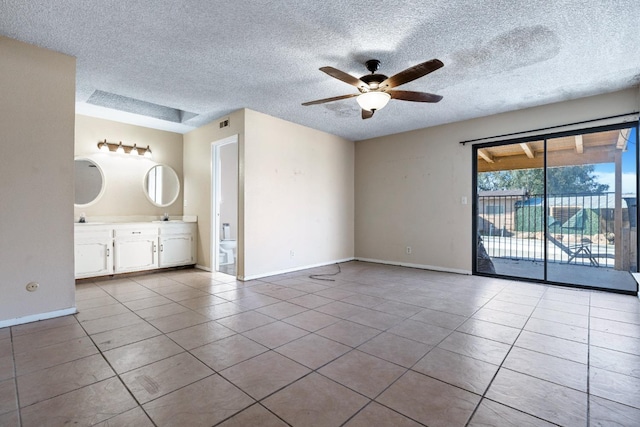 spare room with light tile patterned flooring, ceiling fan, and sink