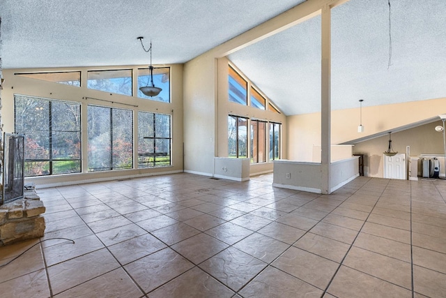 unfurnished living room with high vaulted ceiling and a textured ceiling