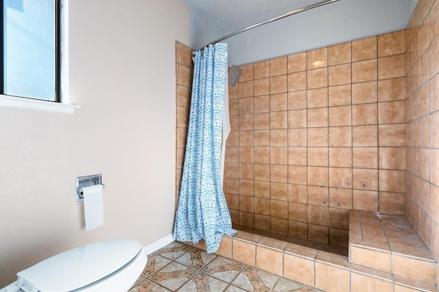 bathroom featuring a shower with curtain, tile patterned flooring, and toilet