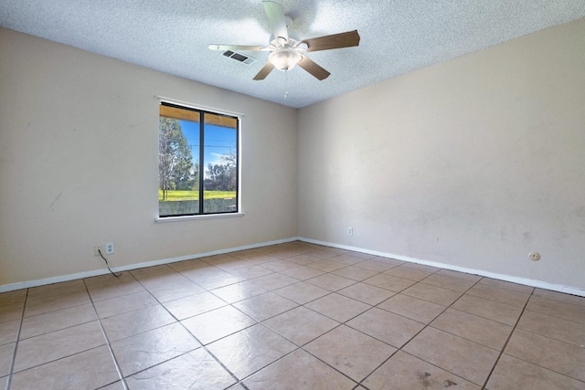 tiled empty room with a textured ceiling and ceiling fan