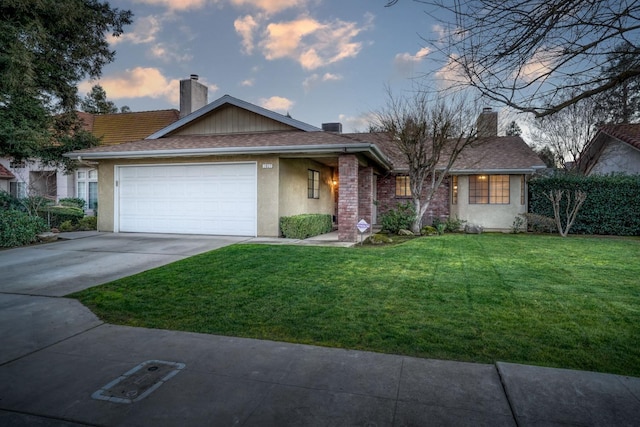 ranch-style house with a garage and a yard