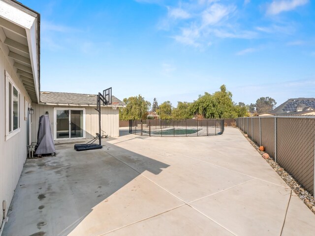 view of patio with a fenced in pool and fence