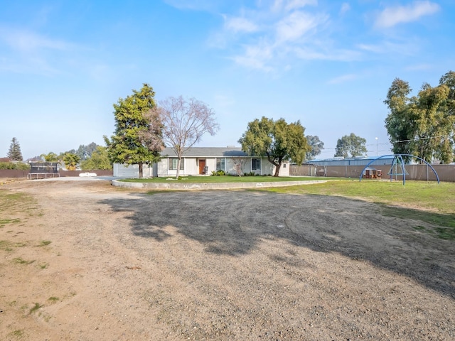 ranch-style house with fence and a front yard