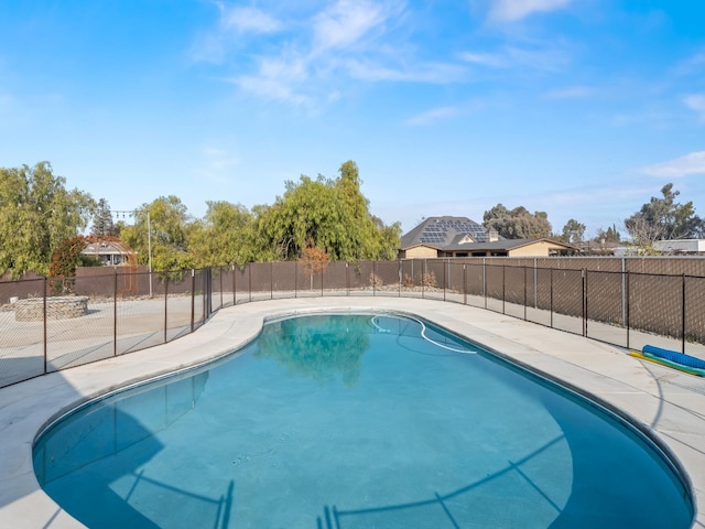 view of swimming pool featuring a fenced in pool and fence