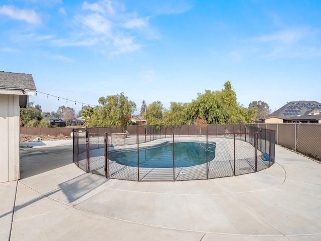 view of swimming pool featuring a fenced in pool, a patio area, and fence