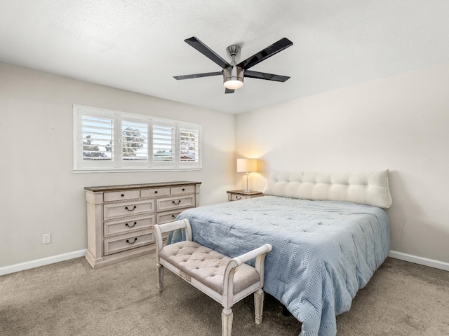 bedroom featuring light carpet, ceiling fan, and baseboards