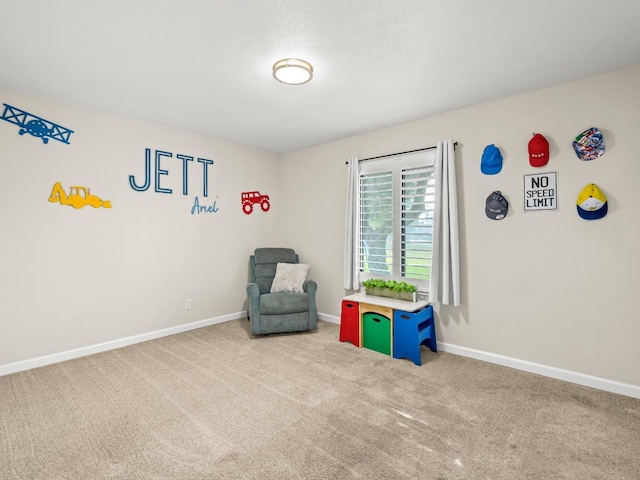 rec room featuring carpet and baseboards