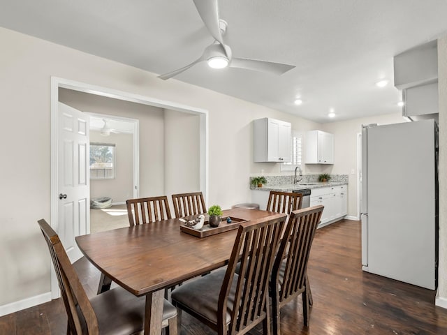 dining room featuring ceiling fan, dark wood-style flooring, and baseboards