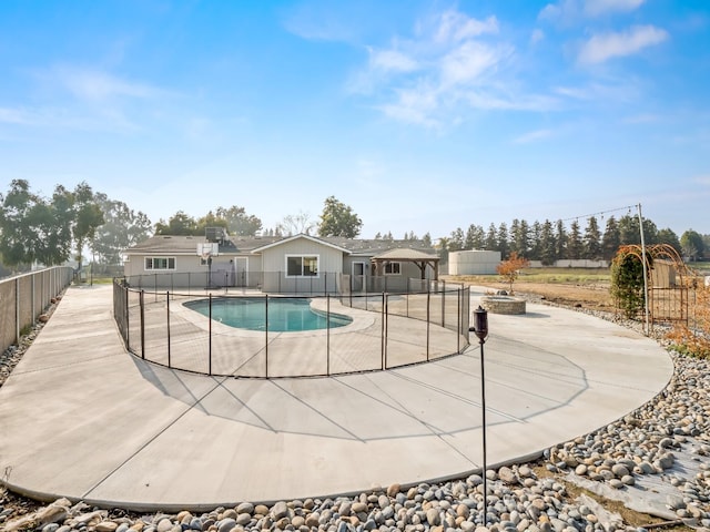 view of swimming pool with a fenced in pool, a patio, and fence