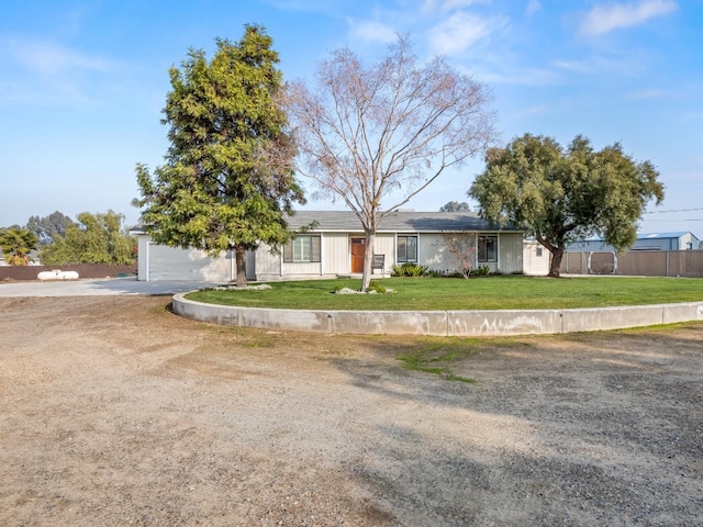 ranch-style house with a front lawn and fence