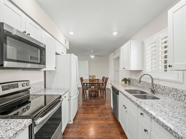 kitchen with white cabinets, ceiling fan, stainless steel appliances, and a sink