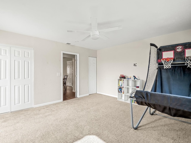 game room featuring carpet floors, baseboards, and a ceiling fan