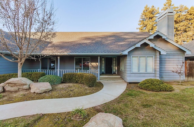 ranch-style home with a porch and a front yard