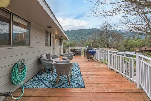 deck featuring a mountain view and area for grilling