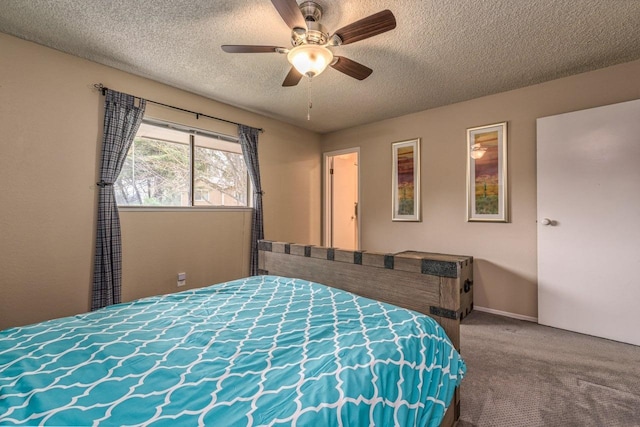 bedroom with ceiling fan, carpet, and a textured ceiling