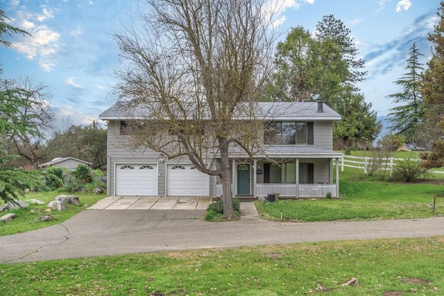 view of front of home featuring covered porch, a front lawn, and a garage