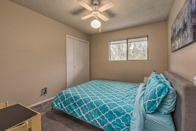 bedroom featuring a textured ceiling, a closet, ceiling fan, and carpet