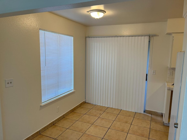 empty room with light tile patterned floors