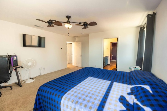 bedroom featuring ceiling fan, connected bathroom, and carpet flooring