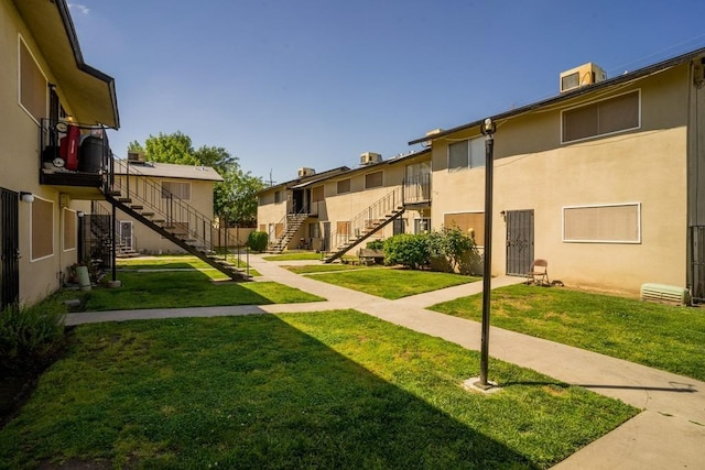 view of property's community with a lawn