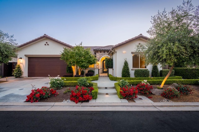 mediterranean / spanish home with a garage