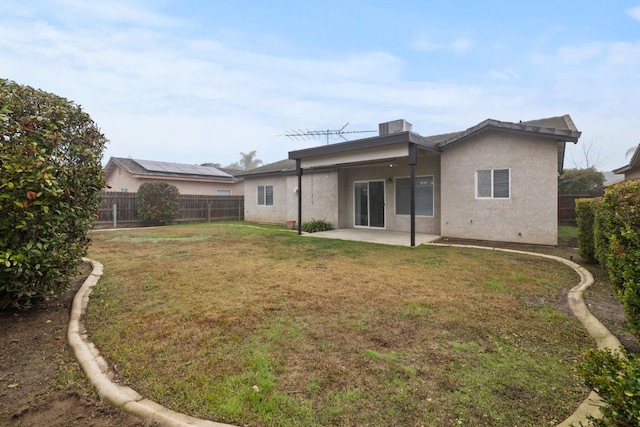 back of property featuring a yard and a patio area