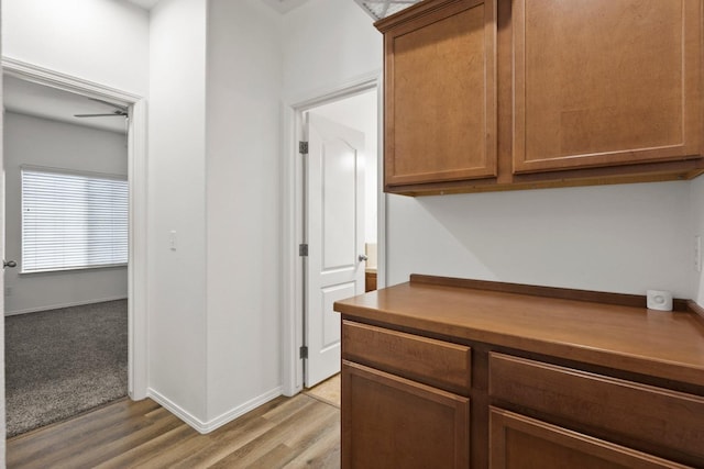 corridor with light hardwood / wood-style flooring