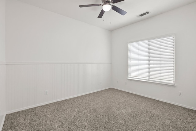 spare room with a healthy amount of sunlight, ceiling fan, and carpet floors